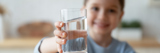 Young girl holding glass of water
