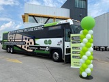 Covid 19 Vaccine Bus parked in front of building