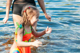 Little girl playing in the water at a beach 