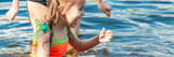Little girl playing in the water at a beach 