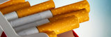Close up of open pack of cigarettes over blue background