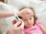 Mom checking daughters temperature