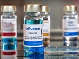 Influenza vaccine bottles on glass table