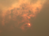 Sun behind clouds and haze from wild fires.