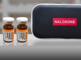 Naloxone kit and bottles sitting on counter